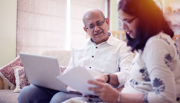 Indian couple browsing pre-paid funeral plans